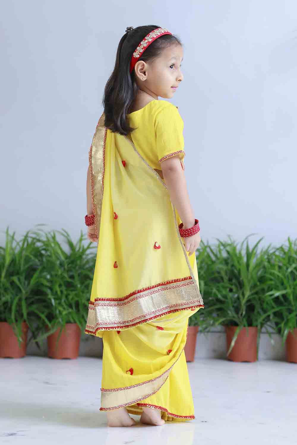 Yellow shaded pre draped sari for infant girls